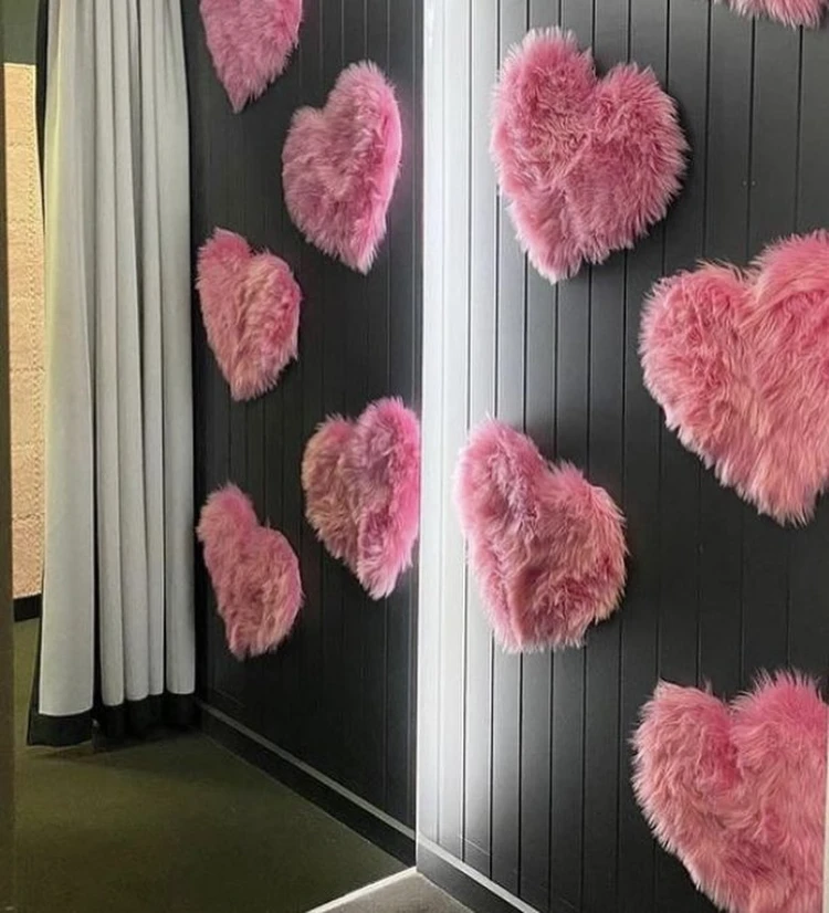 Edgy Pink Faux Fur Hearts on Black Paneling for a Moody Bachelorette