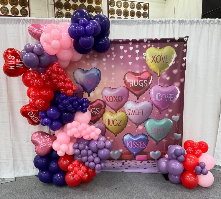 Playful Purple and Red Conversation Heart Backdrop for a Sweet Photo Booth