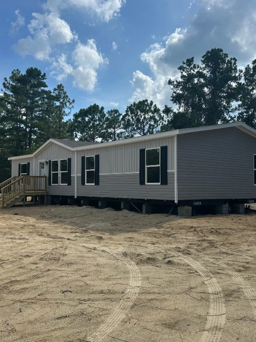 Gray Mobile Home with Black Shutters