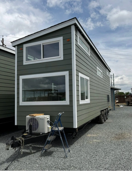 Deep Green Tiny Home with Large Windows