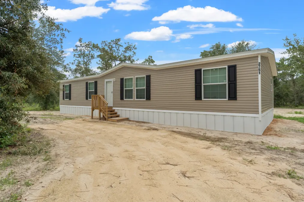 Tan Mobile Home with Black Shutters