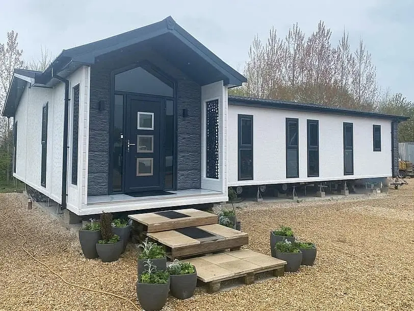 White Mobile Home with a Bold Black Entry